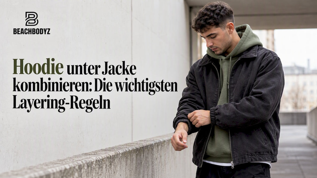 Hoodie unter einer dunklen Jacke im urbanen Streetwear-Style