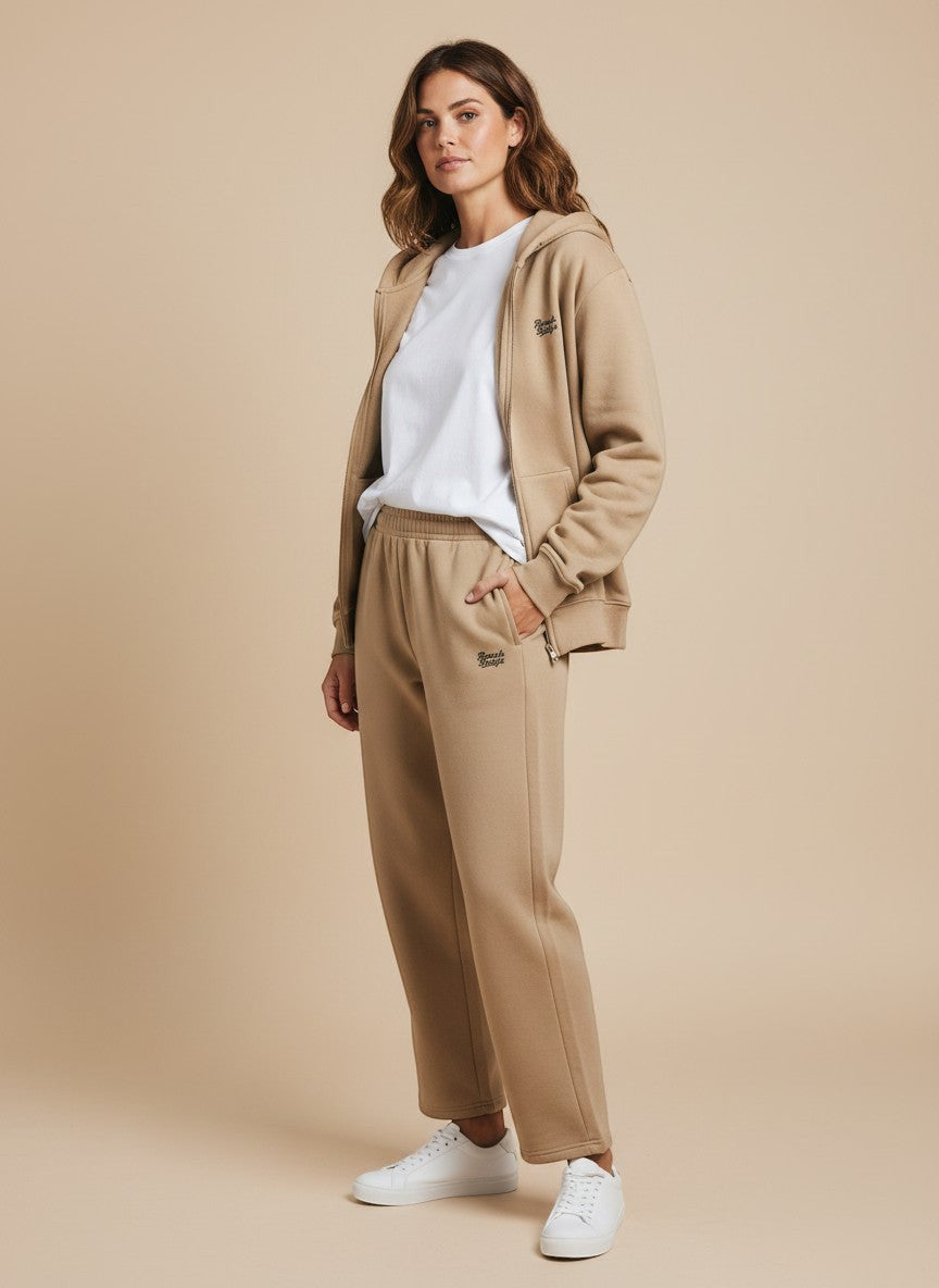 BeachBodyz® beige cotton blend joggers with elastic waistband and subtle logo detail. Comfortable streetwear for men and women.