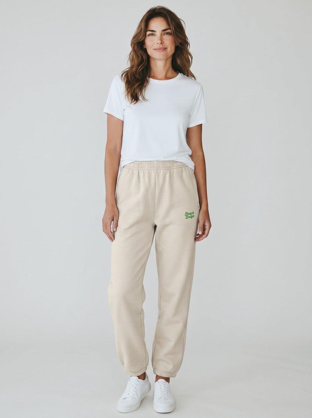 BeachBodyz® oversized beige fluffy cotton blend jogging pants with green logo embroidery.