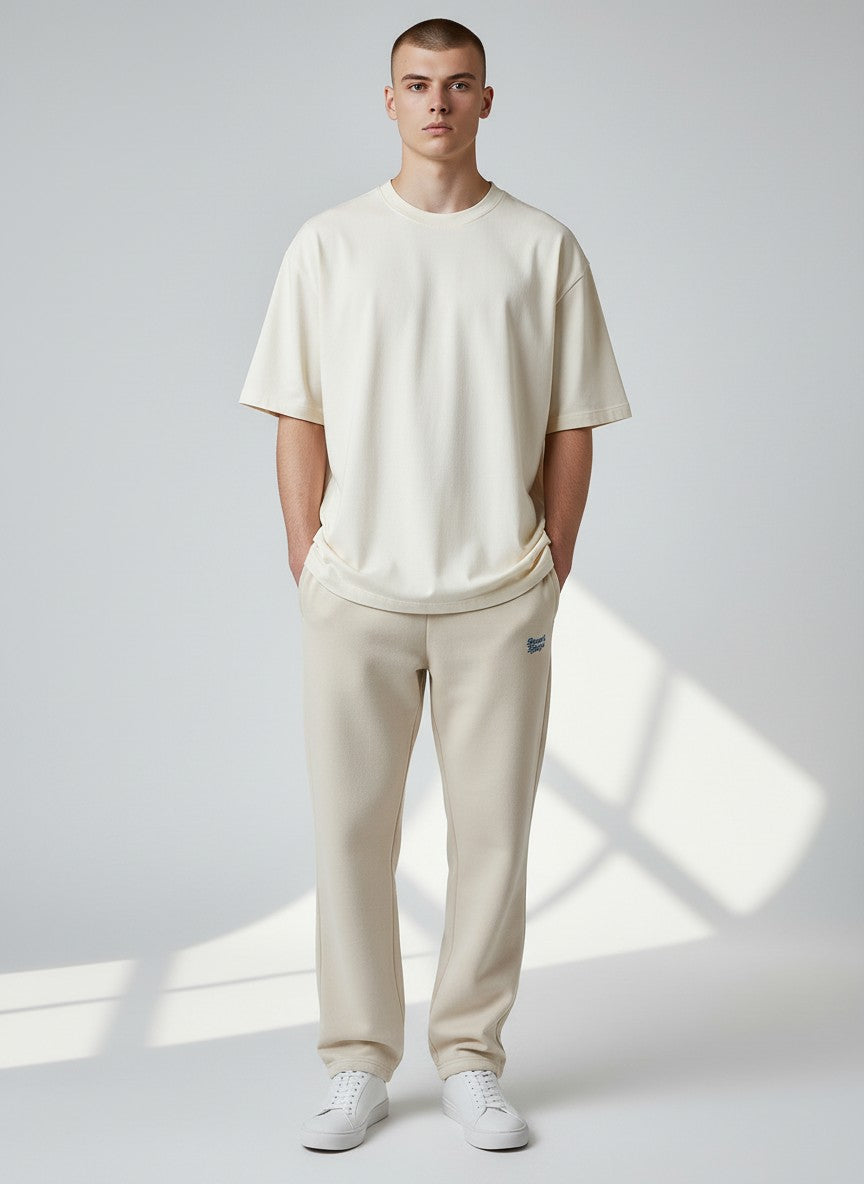 BeachBodyz® beige fluffy cotton blend oversized jogging pants with blue logo embroidery.