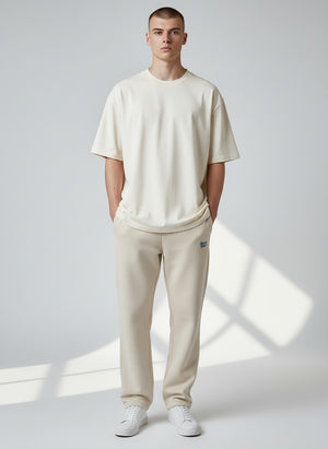BeachBodyz® beige fluffy cotton blend oversized jogging pants with blue logo embroidery.