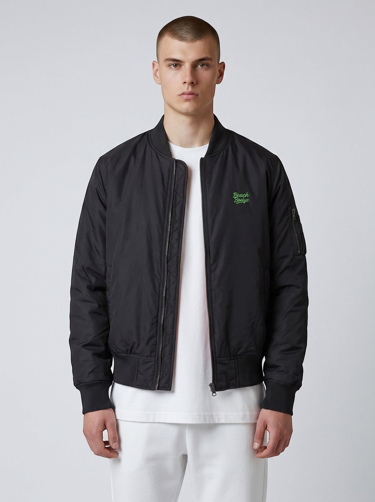 BeachBodyz® black bomber jacket for men and women with orange lining and embroidered logo. Classic streetwear style.