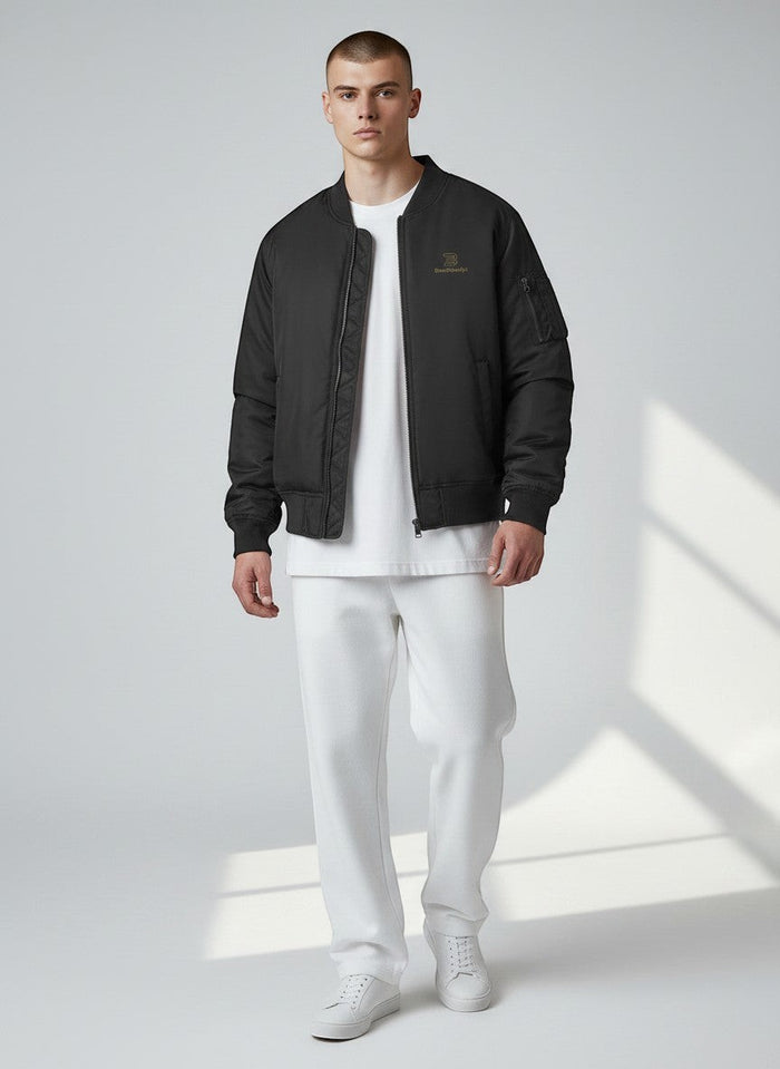 BeachBodyz® black bomber jacket for men and women with gold logo and zip pockets, ideal for streetwear.