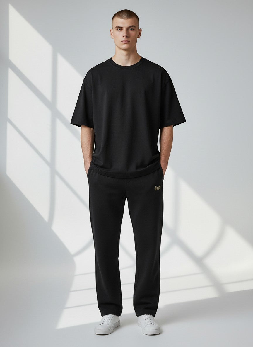 BeachBodyz® black cotton-polyester blend jogginghose with elastic waistband and drawstring, side pockets, and cuffed ankles.
