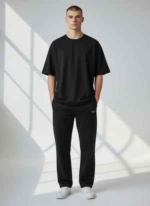 BeachBodyz® black cotton-polyester blend jogginghose with elastic waistband and drawstring, side pockets, and cuffed ankles.