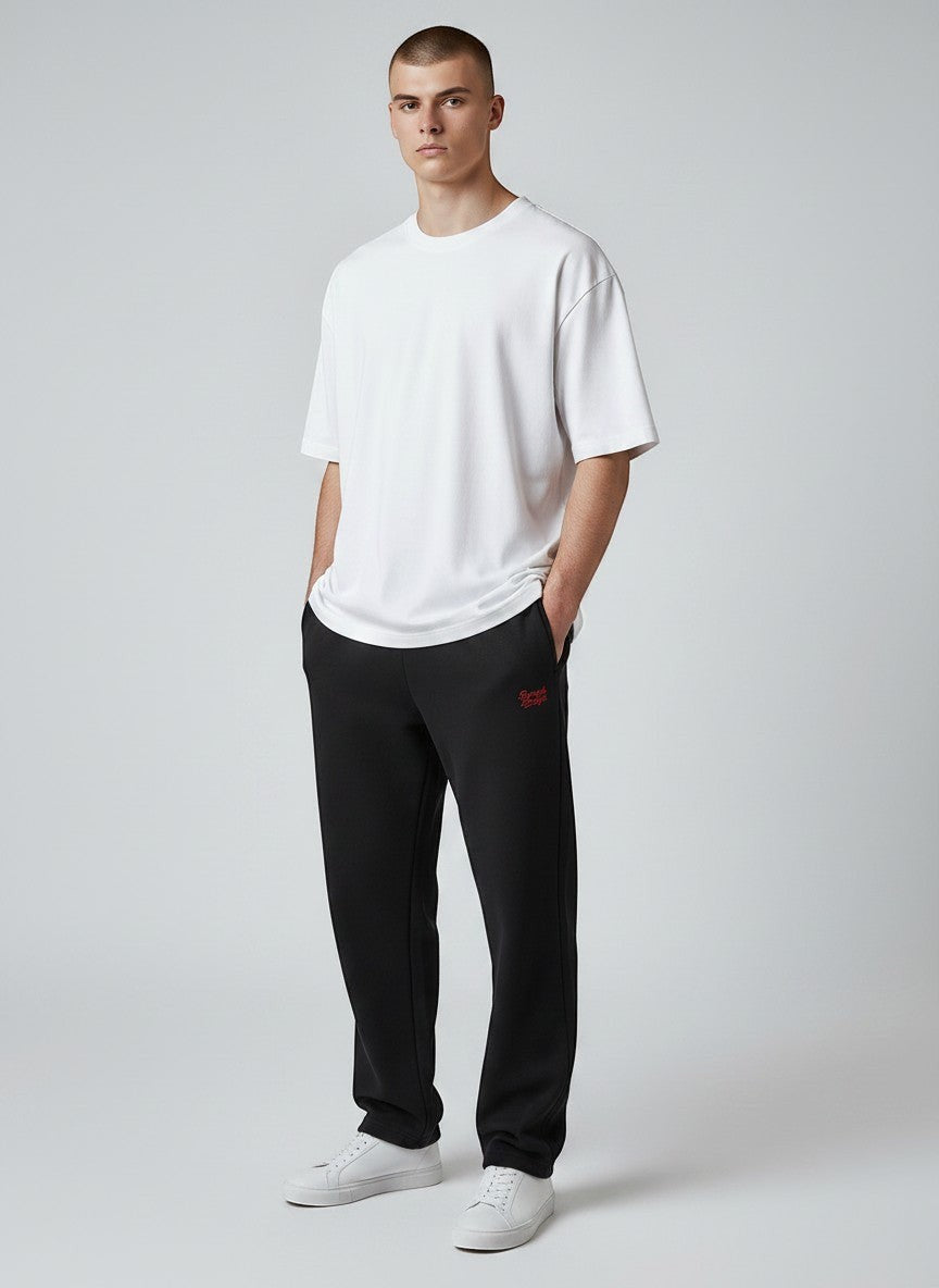 BeachBodyz® black oversized fluffy jogginghose with red logo embroidery, elastic waistband, and cuffed ankles.