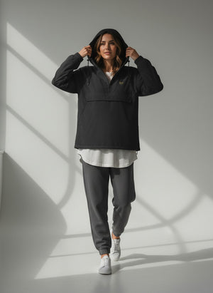 BeachBodyz® black lightweight windbreaker jacket with hood and quarter zip, featuring a chest logo and a large front pocket.