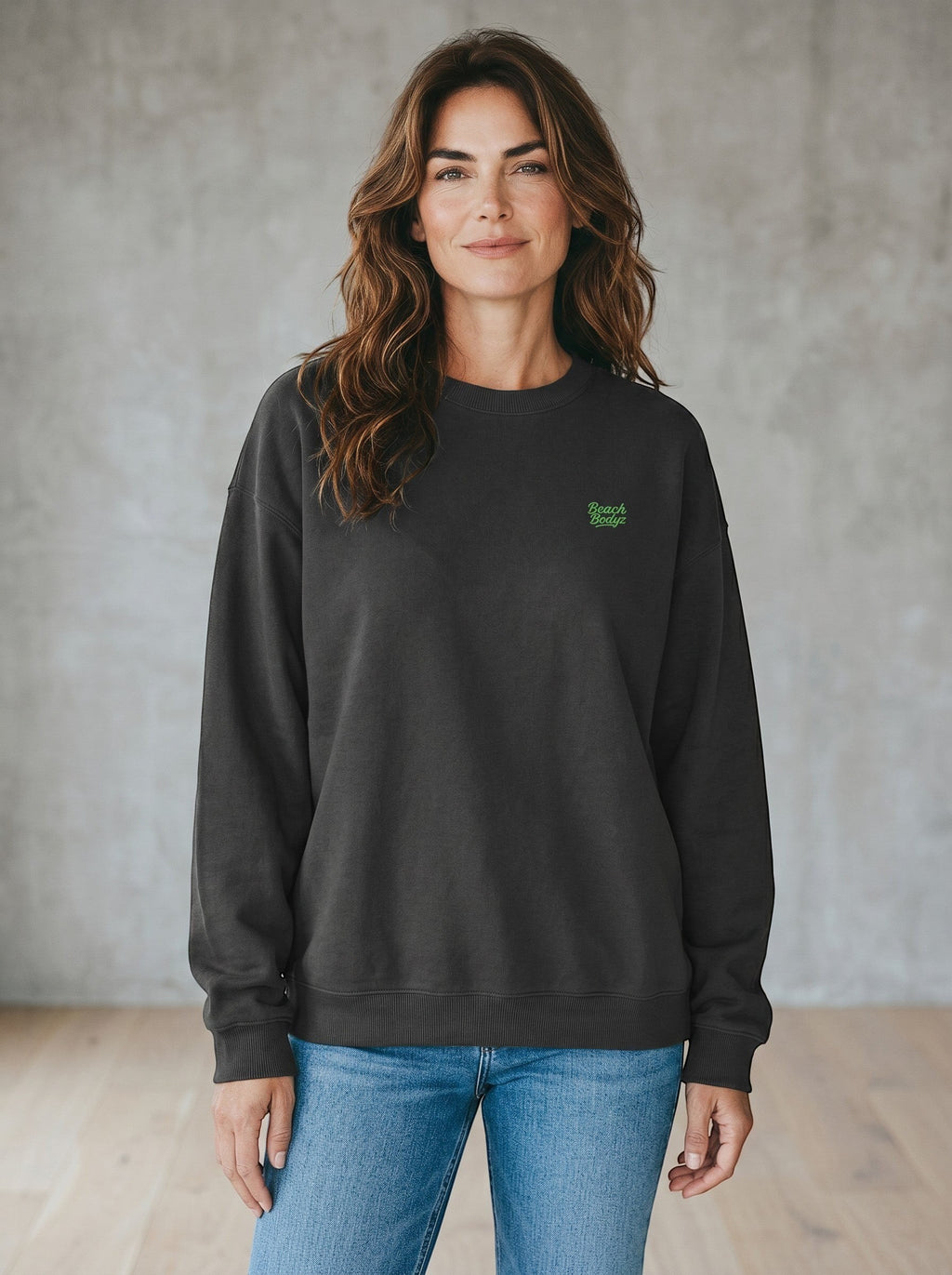 BeachBodyz® black oversized sweatshirt made from organic cotton with a small neon green embroidered logo on the chest.