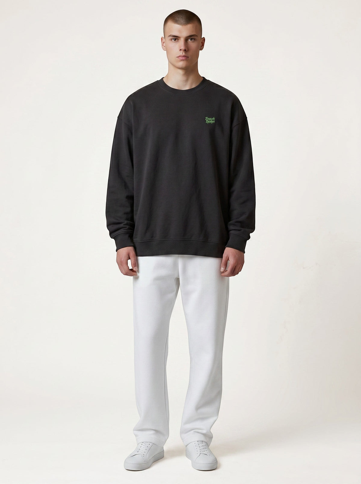 BeachBodyz® black oversized sweatshirt made from organic cotton with a small embroidered neon green logo on the chest.