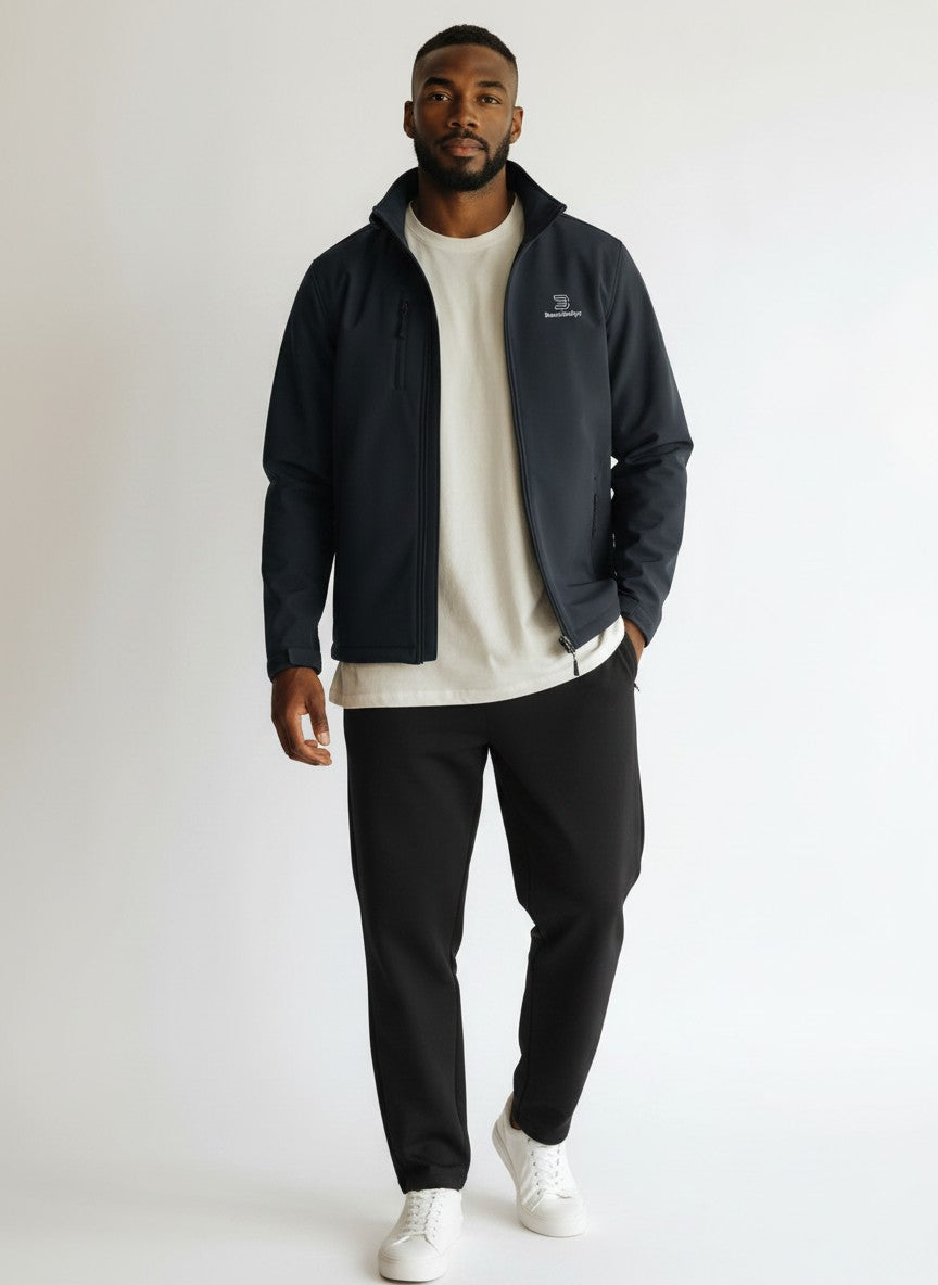 BeachBodyz® Identity softshell jacket for men and women in black, featuring a zip-up front, stand-up collar, and zippered pockets.