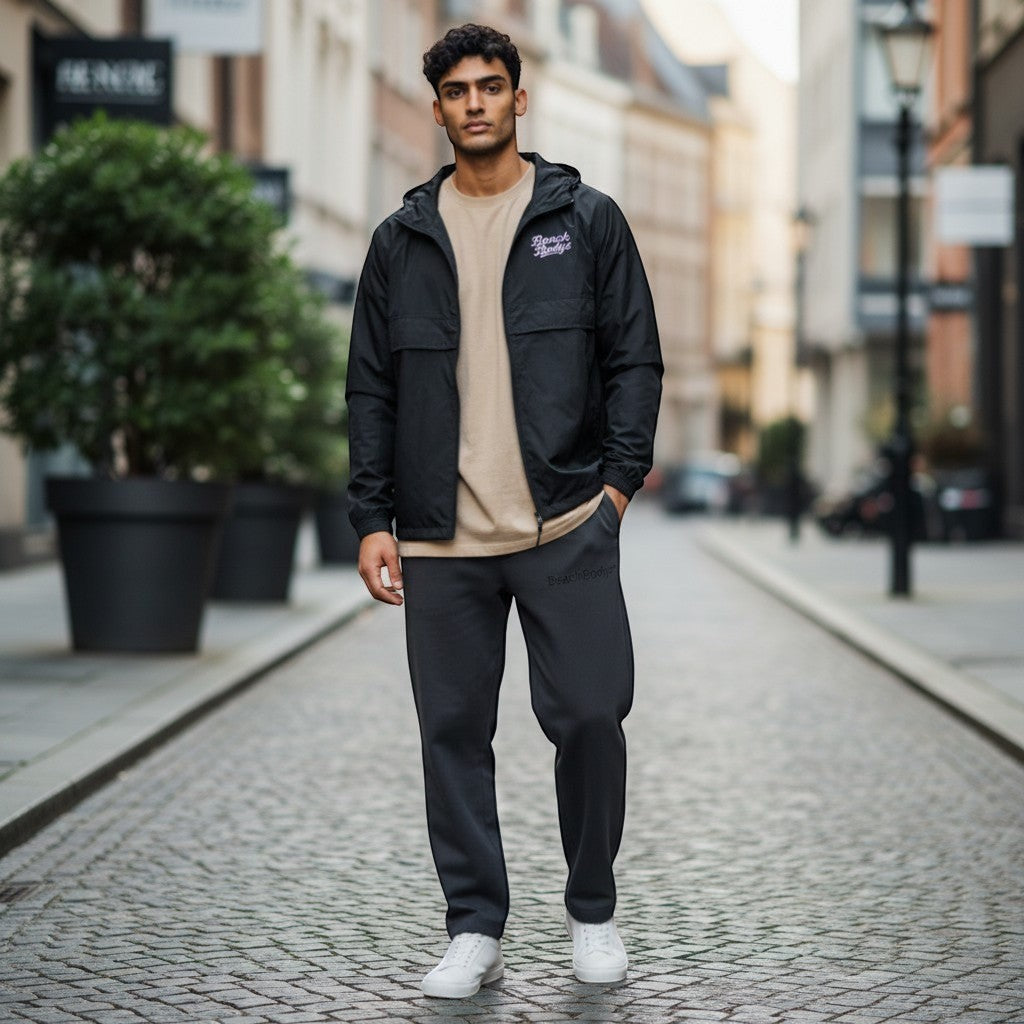 BeachBodyz black lightweight windbreaker jacket with hood and front pouch pocket. Wind-resistant and packable.