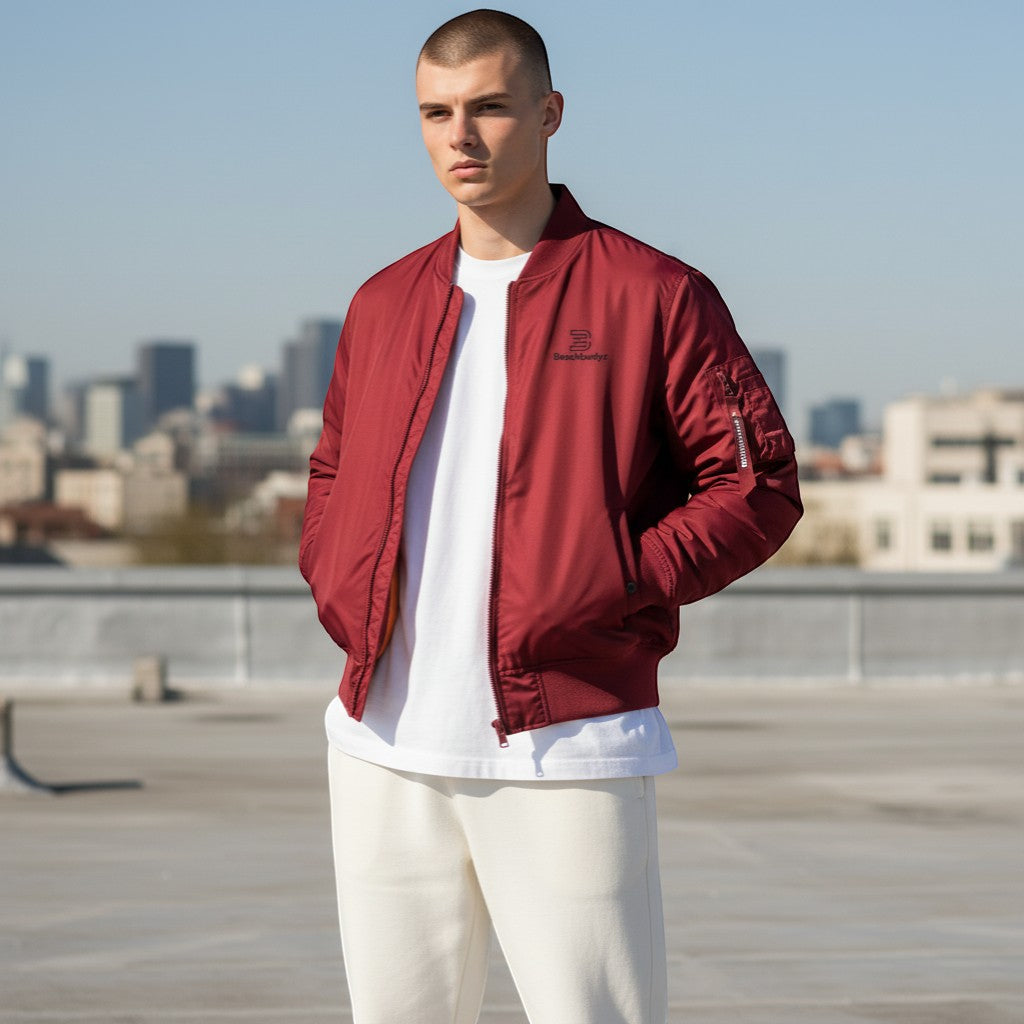 BeachBodyz® burgundy bomber jacket with black logo on chest, ribbed cuffs and hem, and orange lining.