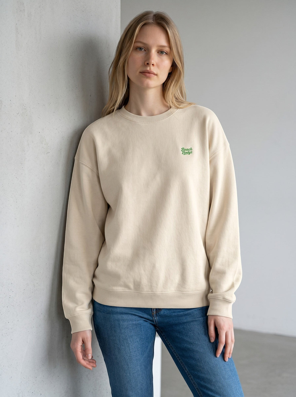 BeachBodyz® cream oversized sweatshirt made from organic cotton with green embroidered logo on chest.