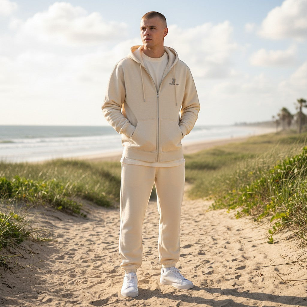BeachBodyz® cream cotton-blend zip-up hoodie with a logo on the chest and front pockets.
