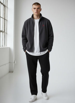 BeachBodyz® dark grey fleece jacket with red logo, full zip, stand-up collar, and side pockets. Unisex streetwear style.