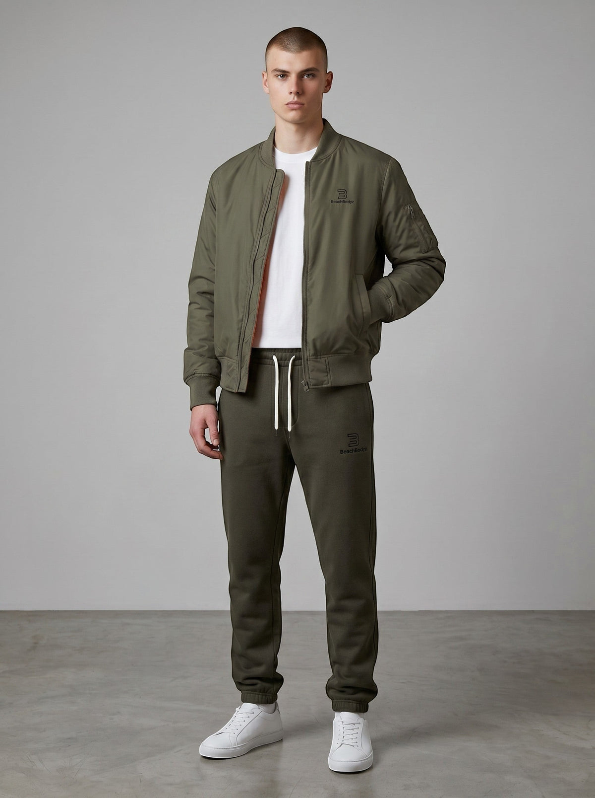 BeachBodyz® dark olive green bomber jacket with orange lining, ribbed cuffs, and zip closure.