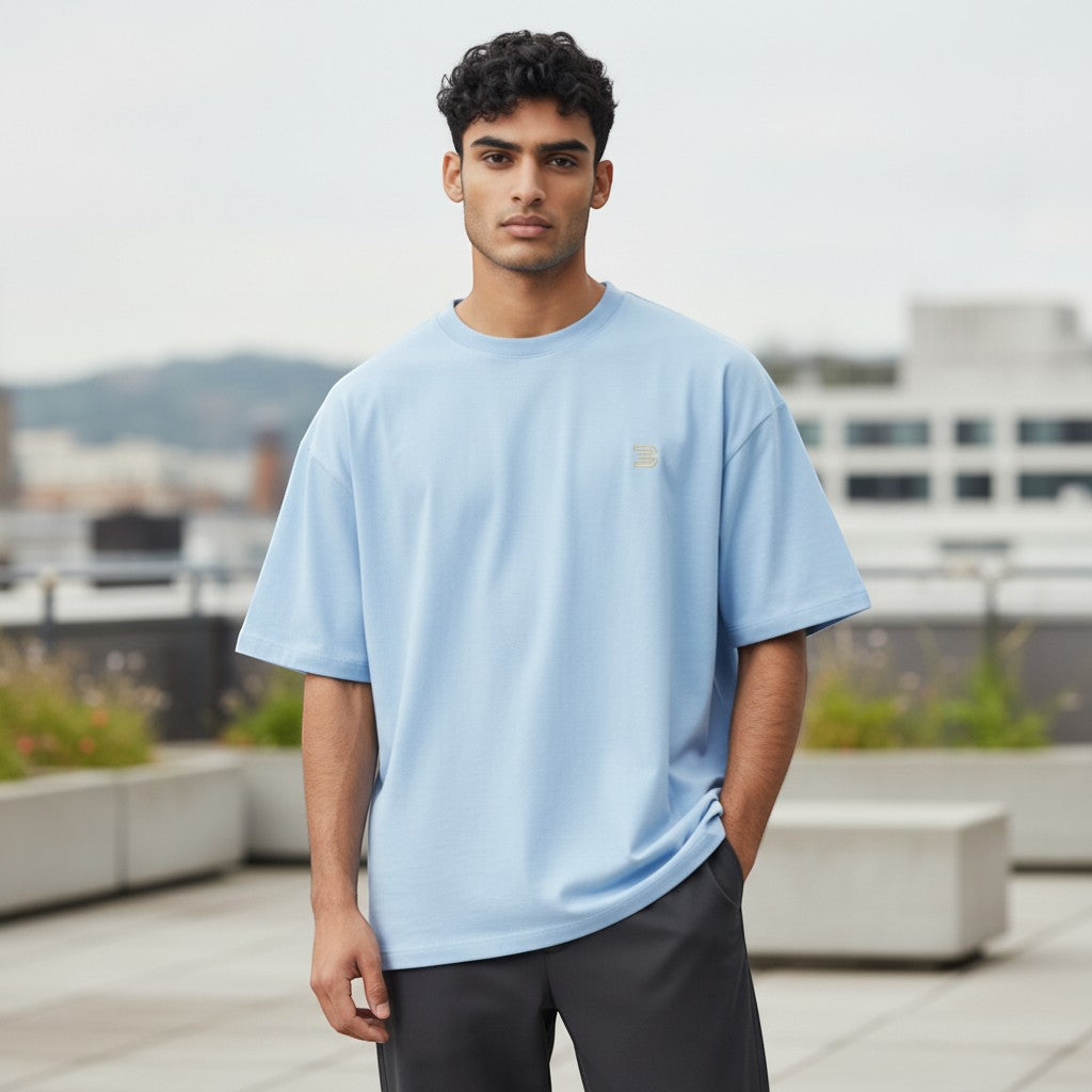 BeachBodyz® light blue oversized cotton t-shirt with a small gold logo on the chest.