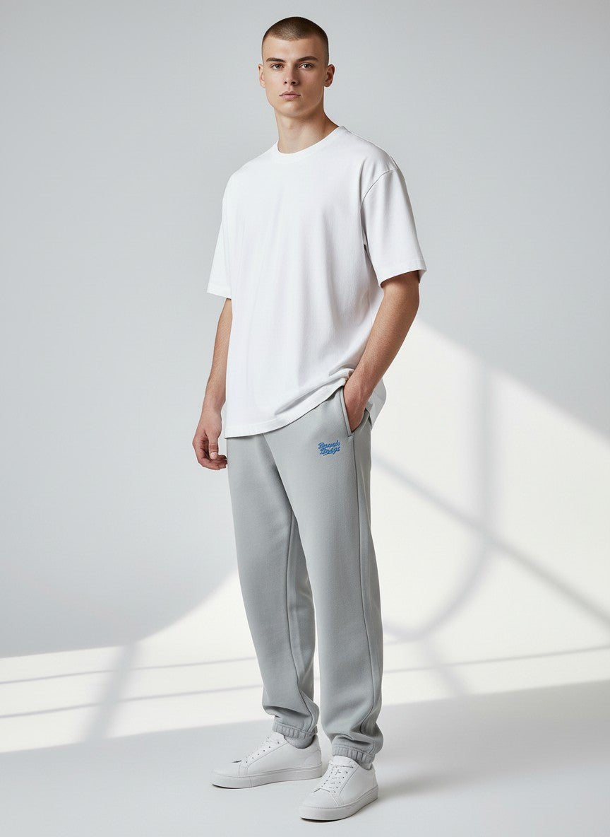 BeachBodyz® light grey fluffy cotton blend oversized jogging pants with blue logo detail and elastic waistband.