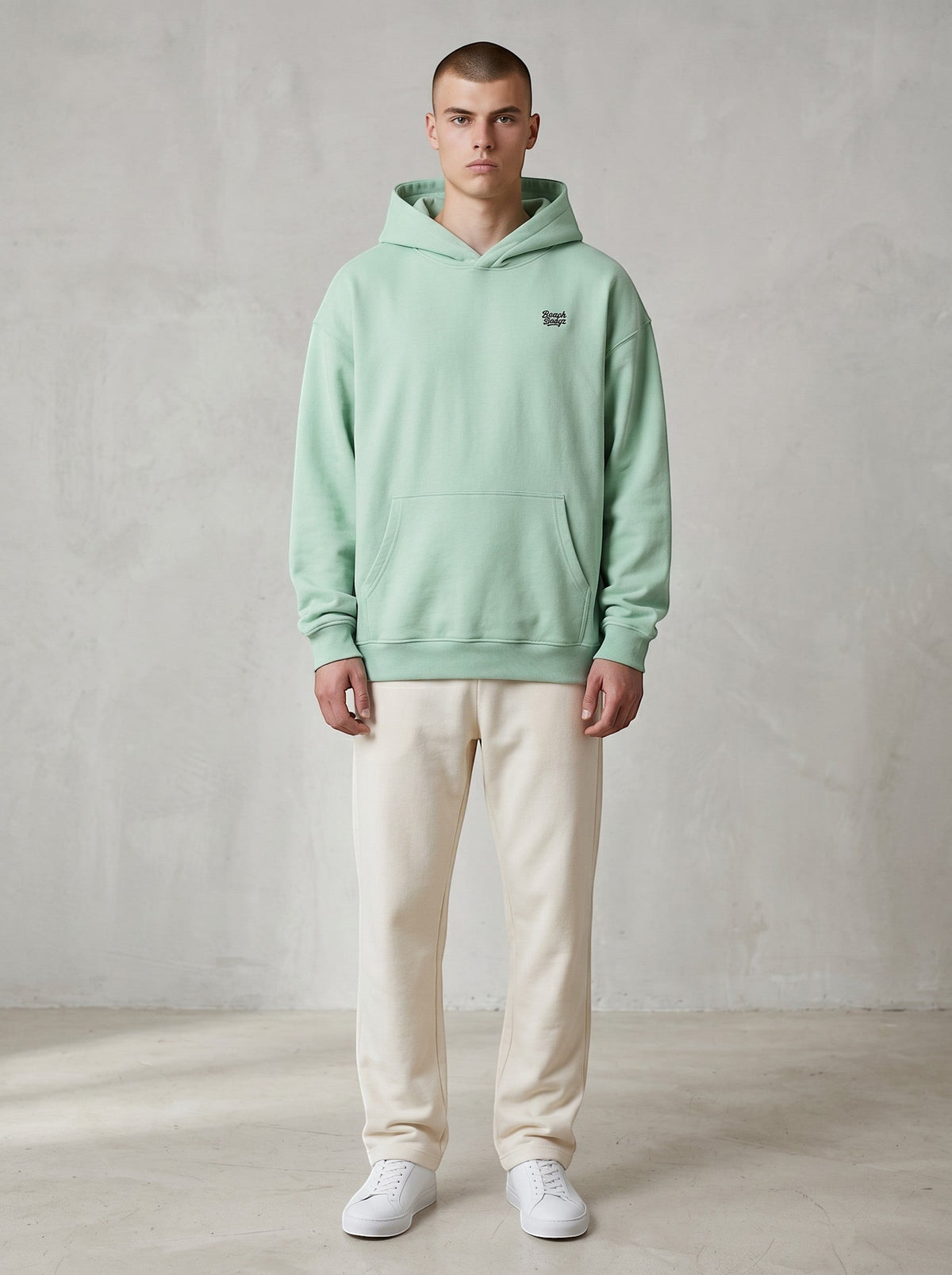BeachBodyz® light mint green oversized hoodie made from bio-cotton with a small embroidered logo on the chest.