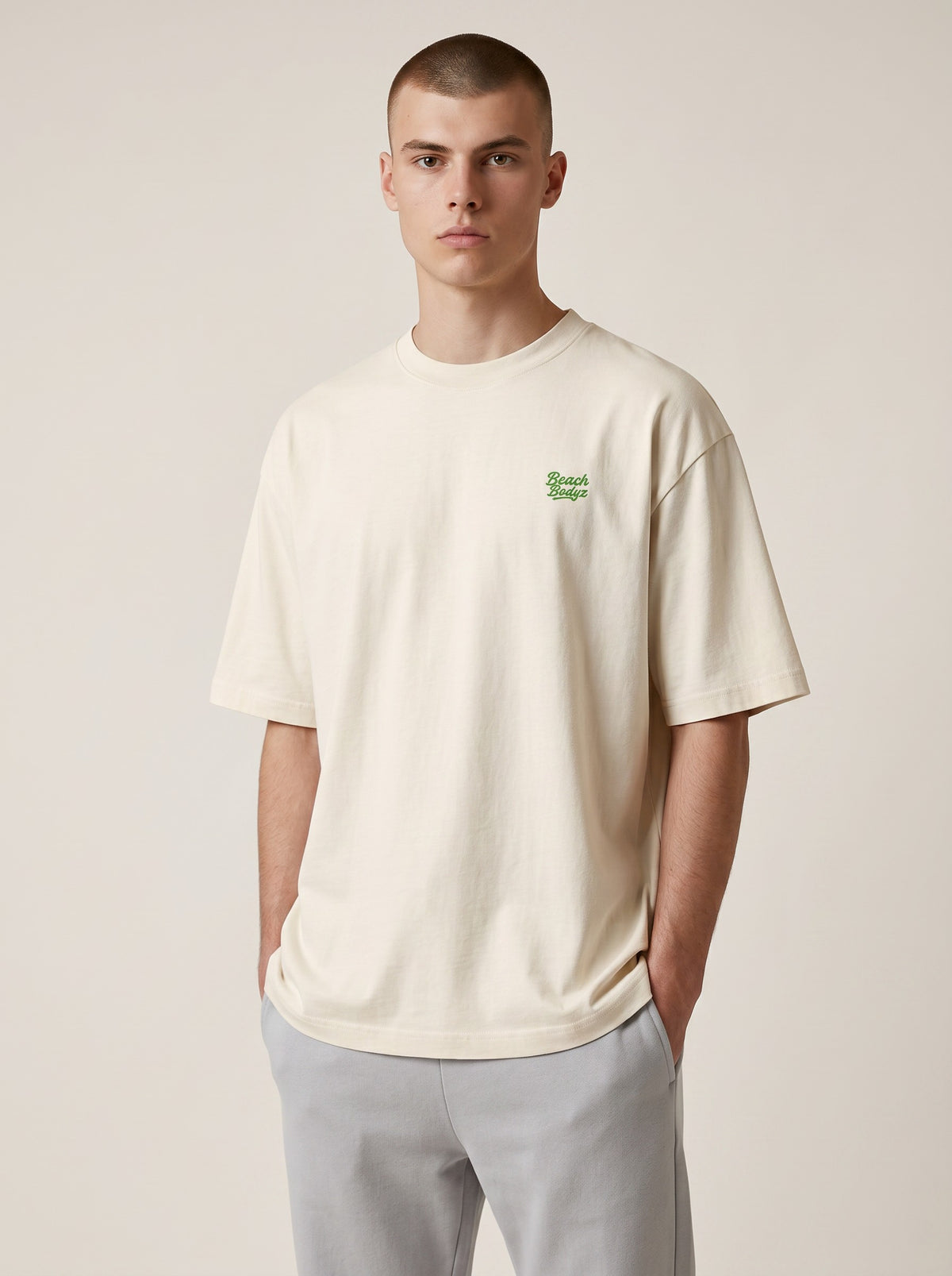 BeachBodyz® natural raw organic cotton oversized t-shirt with green embroidered logo on chest.
