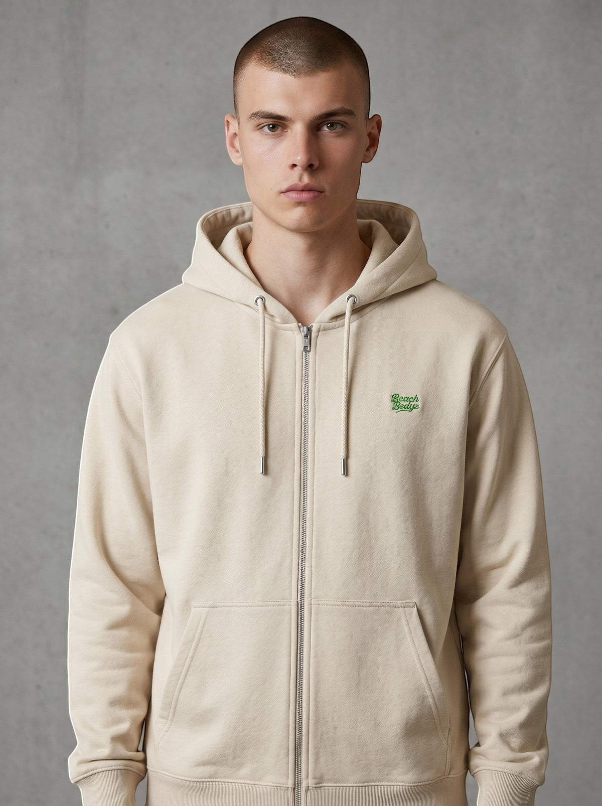 BeachBodyz® natural raw zip-up hoodie with green embroidered logo on chest, made from organic cotton.