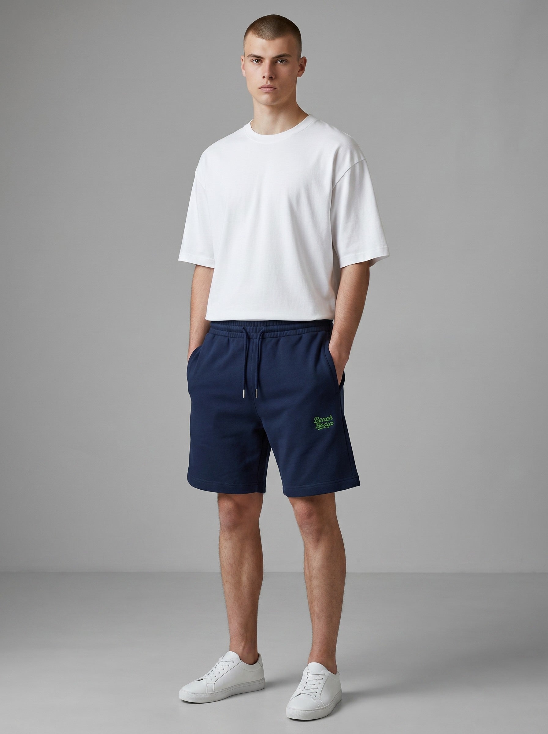 BeachBodyz® navy blue jogger shorts with embroidered logo, made from organic cotton blend, featuring drawstring waist and pockets.