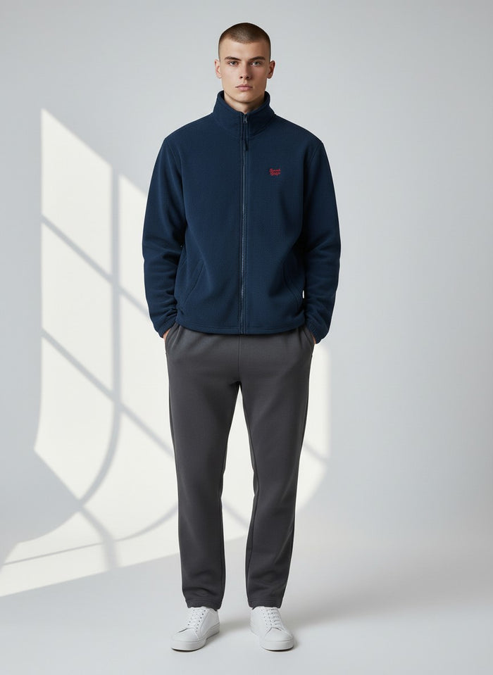 BeachBodyz® navy blue fleece jacket with red logo, full zip, high collar and side pockets. Warm streetwear style.