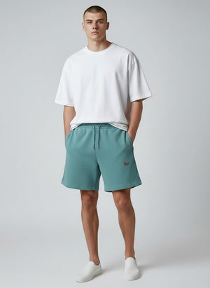 BeachBodyz® teal blue cotton jogger shorts with red embroidered logo and drawstring waist. Casual streetwear style.