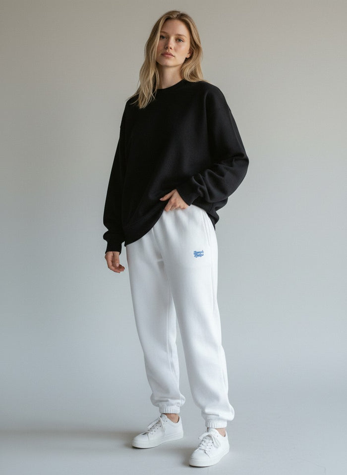 BeachBodyz® white fluffy cotton blend oversized jogging pants with blue logo detail.
