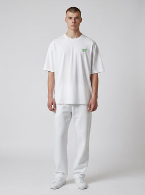 BeachBodyz® white oversized t-shirt made from organic cotton with a small green embroidered logo on the chest.
